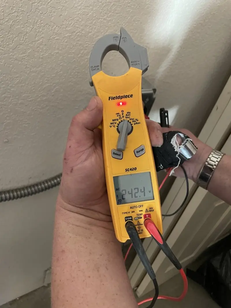 Voltage testing with clamp meter during Recessed Lighting Installation in Baxter